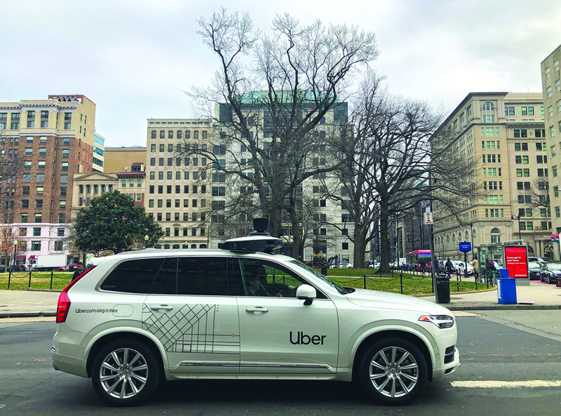 (FILES) In this file photo taken on January 24, 2020 an Uber car equipped with cameras and sensors drives the streets of Washington, DC. - Uber agreed to sell its autonomous car division to Aurora in a deal that gives the ride-hailing giant a stake in the startup developing self-driving technology, the companies said December 7, 2020. (Photo by Eric BARADAT / AFP)