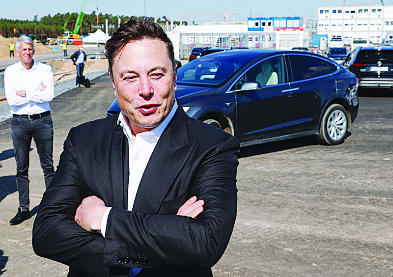 (FILES) In this file photo Tesla CEO Elon Musk talking to media as he arrives to visit the construction site of the future US electric car giant Tesla in Gruenheide near Berlin on September 3, 2020. - Tesla is set to join an elite group of companies in a key Wall Street index, a move which gives greater prominence to the high-flying electric carmaker and forces money managers to reshuffle their portfolios.nThe company founded by Elon Musk becomes part of the Standard &amp; Poor's 500 index on Monday, which means that investment funds based on that index will be holders of the stock. (Photo by Odd ANDERSEN / AFP)