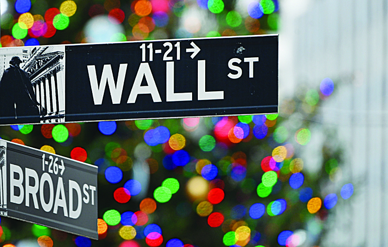 (FILES) In this file photo taken on December 09, 2020 the Wall Street sign at the New York Stock Exchange (NYSE) is seen in New York City. - Wall Street stocks were mostly higher in early trading on 23 December, 2020, shrugging off President Trump's sharp criticism of the stimulus package as the US reached agreement to boost its coronavirus vaccine supply. (Photo by Angela Weiss / AFP)