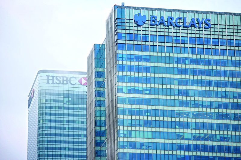 The offices of banking giants HSBC and Barclays are pictured at the secondary central business district of Canary Wharf on the Isle of Dogs in east London on the bank holiday, December 28, 2020. - Business breathed a sigh of relief this week after a post-Brexit trade deal was agreed, but many issues remain unresolved, notably the place of financial services, which represent 80 per cent of the British economy, as the newly inked deal focuses on trade in goods. (Photo by Tolga Akmen / AFP)