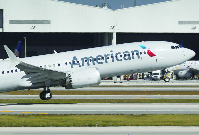 MIAMI, FLORIDA - DECEMBER 29: American Airlines flight 718, a Boeing 737 Max, takes of from Miami International Airport on its way to New York on December 29, 2020 in Miami, Florida. The Boeing 737 Max flew its first commercial flight since the aircraft was allowed to return to service nearly two years after being grounded worldwide following a pair of separate crashes.   Joe Raedle/Getty Images/AFP