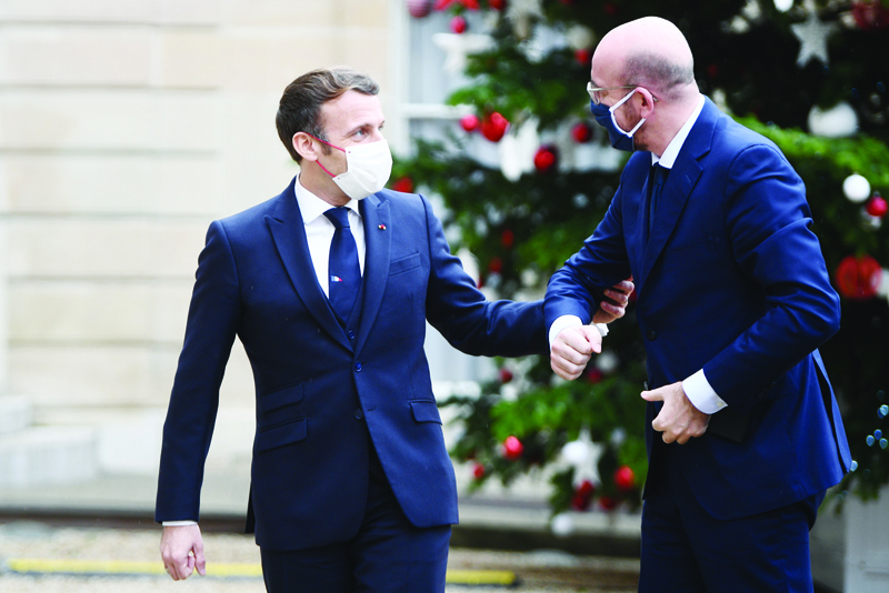 (FILES) In this file photo taken on December 14, 2020 French President Emmanuel Macron (L) welcomes European council president Charles Michel prior to a meeting marking the 60th anniversary of the creation of the Organisation for Economic Co-operation and Development (OECD) at the Elysee palace in Paris. - Charles Michel has entered self-isolation, his spokesman said on December 17, 2020 after meeting France's President Emmanuel Macron earlier in the week. (Photo by Martin BUREAU / POOL / AFP)