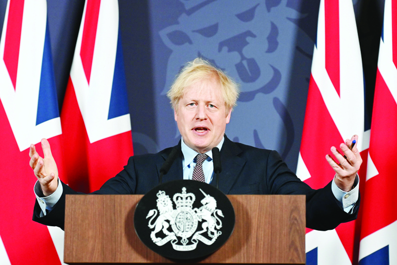 TOPSHOT - Britain's Prime Minister Boris Johnson gestures as he holds a remote press conference to update the nation on the post-Brexit trade agreement, inside 10 Downing Street in central London on December 24, 2020. - Britain said on Thursday, December 24, 2020 an agreement had been secured on the country's future relationship with the European Union, after last-gasp talks just days before a cliff-edge deadline. (Photo by Paul GROVER / POOL / AFP)