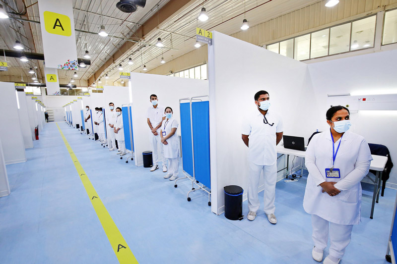 Medical staff stand ready at the Kuwait vaccination center for COVID-19 at the International Fairgrounds in Kuwait City on December 23, 2020. (Photo by YASSER AL-ZAYYAT / AFP)
