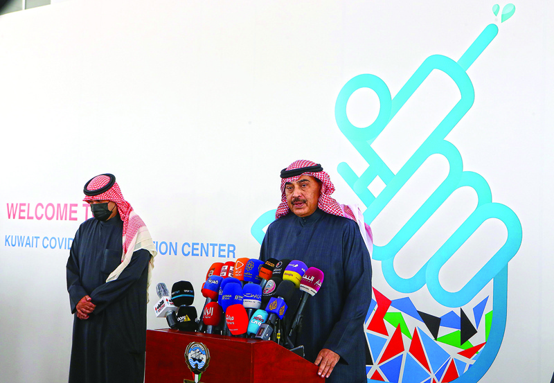 Kuwaiti Prime Minister Sheikh Sabah al-Khaled al-Sabah (R) gives a press conference at a vaccination centre set up in the Kuwait International Fairground in the capital Kuwait City, on December 24, 2020. - Some Gulf countries have started rolling out their vaccination programmes, with Kuwait and Oman announcing they will start inoculating people with the Pfizer-BioTech vaccine today and December 27, respectively. (Photo by YASSER AL-ZAYYAT / AFP)