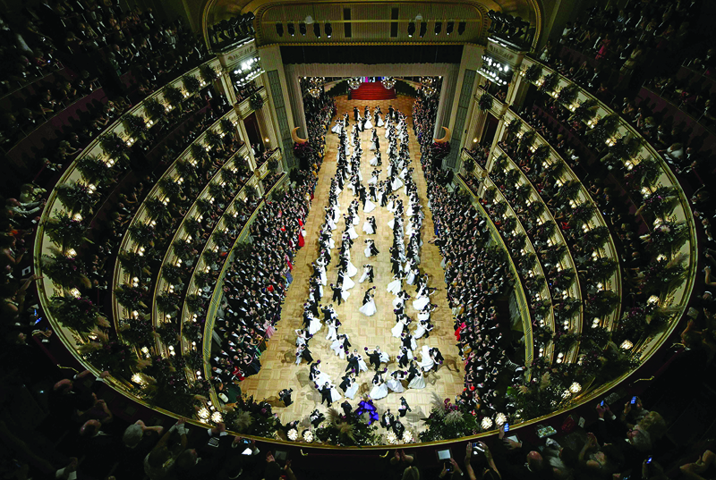 (FILES) In this file photo taken on February 20, 2020 Overall view taken as debutant dancers dance the first dance during the annual Opera Ball in Vienna, Austria. - Vienna, a city temple of culture turned ghost town: the traditional New Year's concert will take place, but without an audience. As for the ball season, the pandemic has been fatal. (Photo by HERBERT NEUBAUER / APA / AFP) / Austria OUT