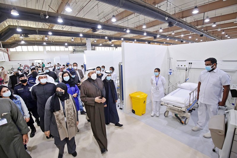 Kuwaiti health minister Sheikh Basel al-Sabah (C) tours the Kuwait vaccination center for COVID-19 at the International Fairgrounds in Kuwait City on December 23, 2020. (Photo by YASSER AL-ZAYYAT / AFP)