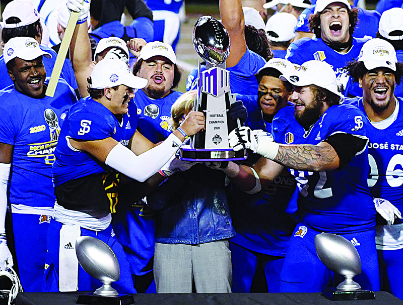 LAS VEGAS, NEVADA - DECEMBER 19: Quarterback Nick Starkel (2nd L) #17 and defensive lineman Cade Hall #92 lift the championship trophy after defeating the Boise State Broncos 34-20 to win the Mountain West Football Championship at Sam Boyd Stadium on December 19, 2020 in Las Vegas, Nevada.   Ethan Miller/Getty Images/AFPn== FOR NEWSPAPERS, INTERNET, TELCOS &amp; TELEVISION USE ONLY ==