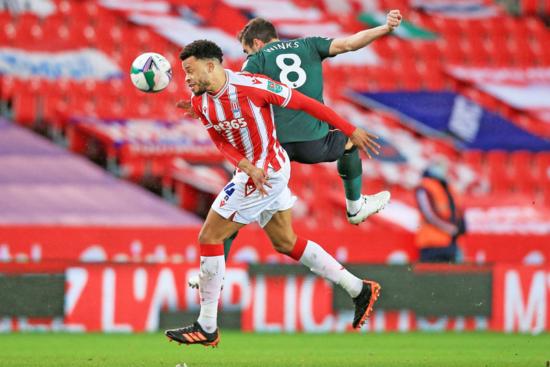 Stoke City's English midfielder Jordan Cousins (L) vies for the ball against Tottenham Hotspur's English midfielder Harry Winks (R) during the English League Cup quarter final football match between Stoke City and Tottenham Hotspur at the bet365 Stadium, in Stoke on Trent on December 23, 2020. (Photo by Lindsey Parnaby / AFP) / RESTRICTED TO EDITORIAL USE. No use with unauthorized audio, video, data, fixture lists, club/league logos or 'live' services. Online in-match use limited to 120 images. An additional 40 images may be used in extra time. No video emulation. Social media in-match use limited to 120 images. An additional 40 images may be used in extra time. No use in betting publications, games or single club/league/player publications. /