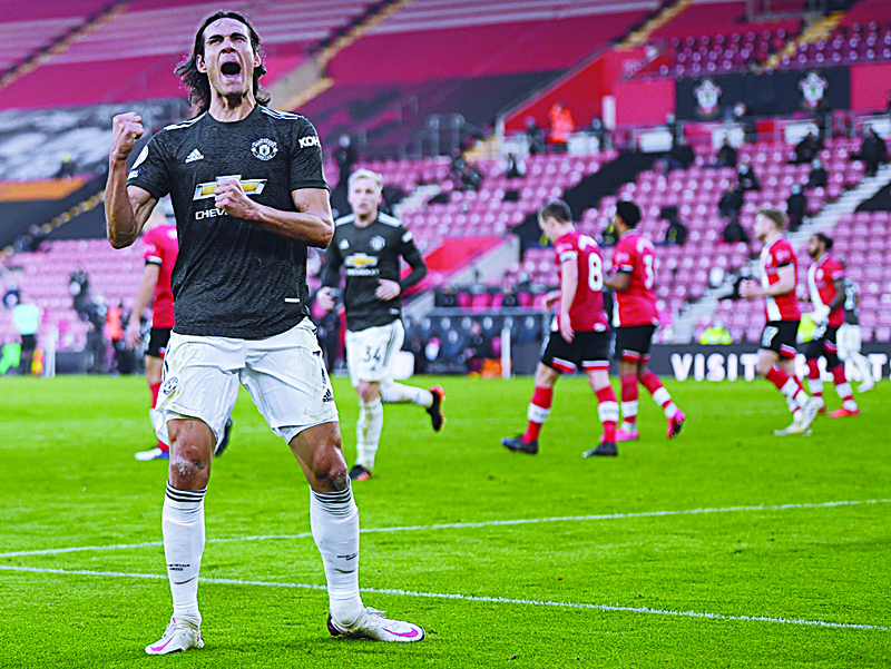 (FILES) In this file photo taken on November 29, 2020 Manchester United's Uruguayan striker Edinson Cavani celebrates scoring their second goal during the English Premier League football match between Southampton and Manchester United at St Mary's Stadium in Southampton, southern England on November 29, 2020. - Edinson Cavani has been charged with misconduct by the Football Association for a now-deleted social media post containing a Spanish phrase that is offensive in some contexts and for which the Manchester United star apologised. (Photo by Mike Hewitt / POOL / AFP) / RESTRICTED TO EDITORIAL USE. No use with unauthorized audio, video, data, fixture lists, club/league logos or 'live' services. Online in-match use limited to 120 images. An additional 40 images may be used in extra time. No video emulation. Social media in-match use limited to 120 images. An additional 40 images may be used in extra time. No use in betting publications, games or single club/league/player publications. /
