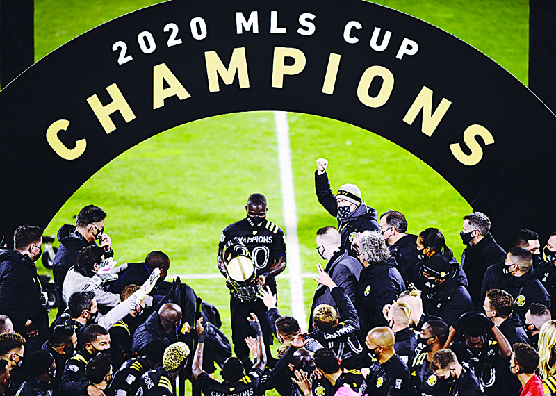 COLUMBUS, OHIO - DECEMBER 12: Jonathan Mensah #4 of Columbus Crew brings his team the MLS Cup after a 3-0 win over the Seattle Sounders during the MLS Cup Final at MAPFRE Stadium on December 12, 2020 in Columbus, Ohio.   Emilee Chinn/Getty Images/AFPn== FOR NEWSPAPERS, INTERNET, TELCOS &amp; TELEVISION USE ONLY ==