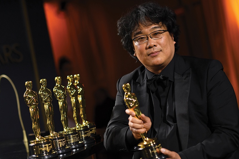 In this file photo South Korean film director Bong Joon Ho poses with his engraved awards as he attends the 92nd Oscars Governors Ball at the Hollywood & Highland Center in Hollywood, California.-AFP n