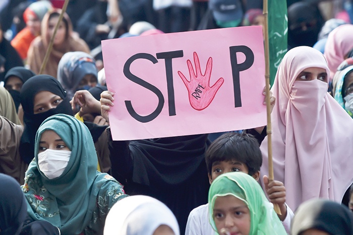 In this file photo taken, a supporter of Pakistani Islamic political party Jamaat-e-Islami (JI) holds a placard reading “Stop” during a protest against an alleged gang rape of a woman, in Lahore. — AFPn