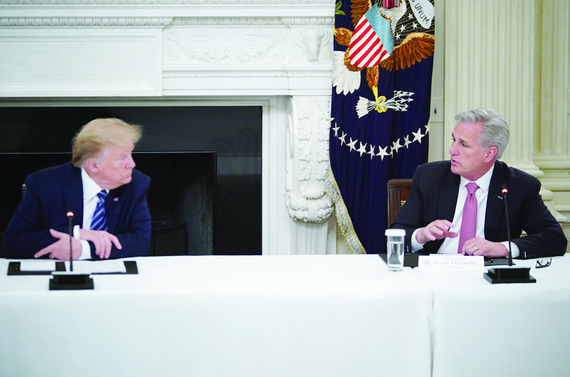 WASHINGTON, DC: In this file photo taken on May 08, 2020, then US President Donald Trump speaks with US representative Kevin McCarthy as he meets with Republican members of the US Congress in the State Dining Room of the White House in Washington, DC. - AFPn