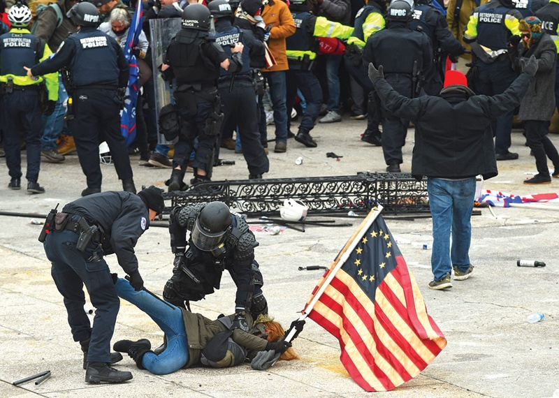 WASHINGTON, DC: Police detain a person as supporters of US President Donald Trump protest outside the US Capitol in Washington, DC. A man with a loaded handgun and more than 500 rounds of ammunition has been arrested in Washington at a security checkpoint near the US Capitol, authorities said. -- AFPn