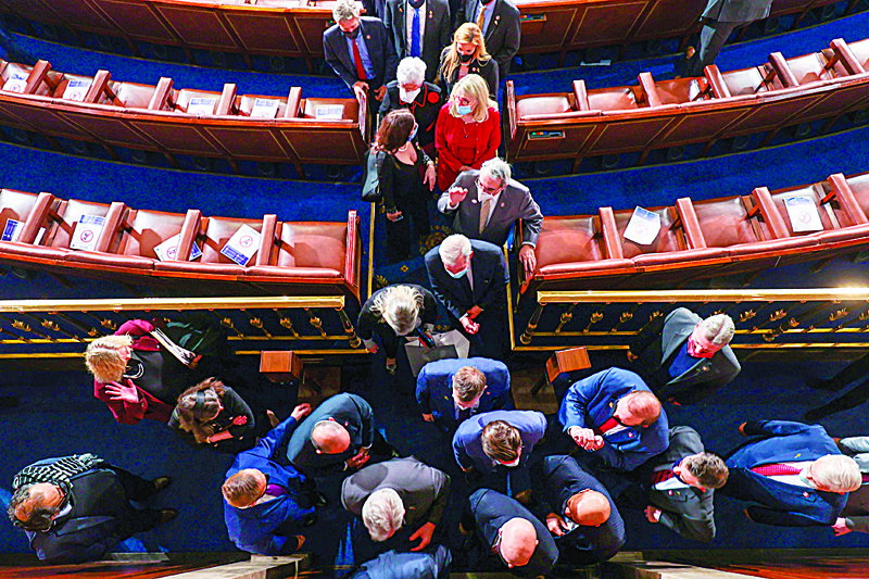 Members of the house depart after the first session of the 117th Congress in the House Chamber at the US Capitol on January 3, 2021 in Washington, DC. (Photo by Tasos Katopodis / POOL / AFP)