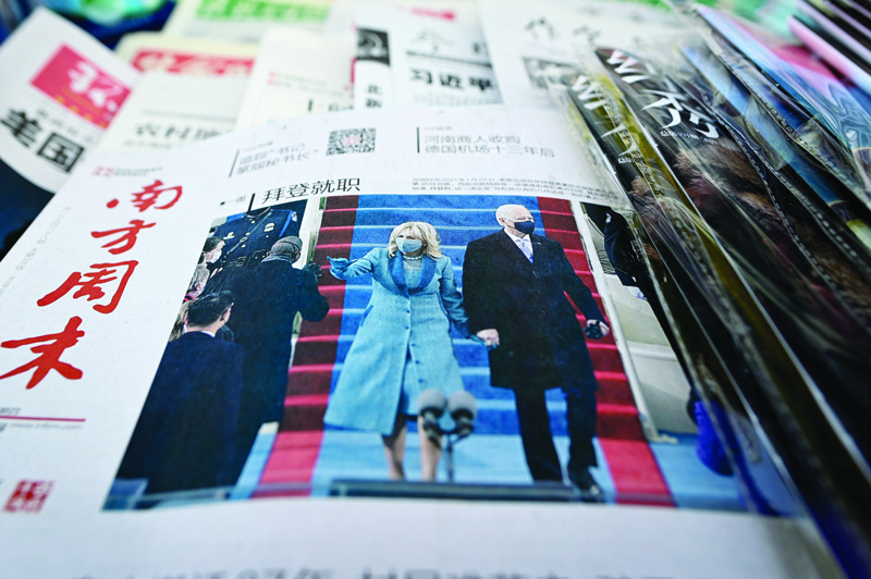 BEIJING: The front page of a Chinese newspapers showing the picture of the inauguration of US President Joe Biden, the 46th US President, at a newsstand in Beijing yesterday. – AFPn