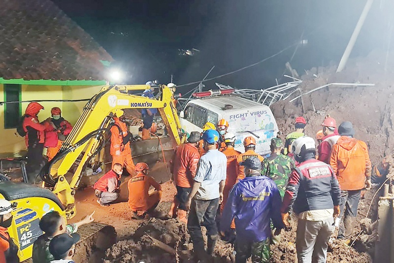INDONESIA: Rescuers searching for survivors after landslides killed at least 11 people in Sumedang yesterday. -AFP n