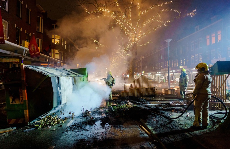 ROTTERDAM, Netherlands: Firefighters work to extinguish a fire on the Groene Hilledijk on Monday, after a second wave of riots in the Netherlands following the introduction of a coronavirus curfew over the weekend. - AFP n
