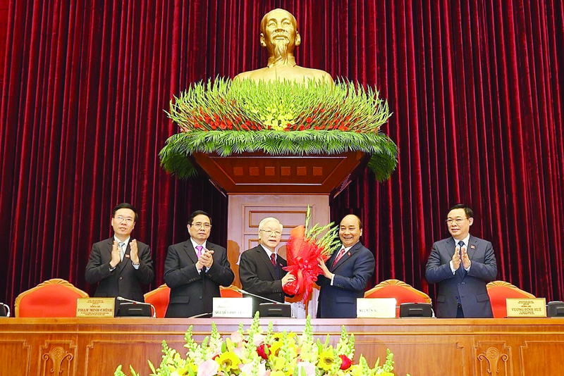 HANOI, Vietnam : This picture shows Vietnam's Prime Minister Nguyen Xuan Phuc (second right) congratulating the new Communist Party general secretary Nguyen Phu Trong (center left) after his re-election during the Communist Party of Vietnam (CPV) 13th National Congress in Hanoi, as other nominated top party leaders Vuong Dinh Hue (right), Pham Minh Chinh (second left) and Vo Van Thuong (left) applaud.-AFP n