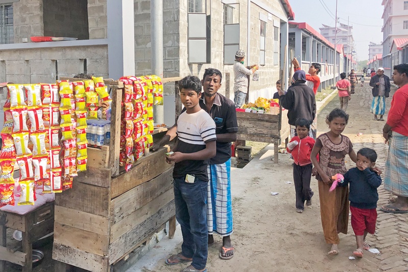 Rohingya refugees are seen next to eatery stalls at the housing complex of Bhashan Char island after they were relocated in Noakhali. - AFPn