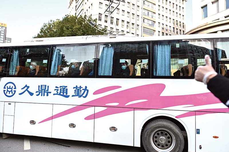 WUHAN: Members of the World Health Organization (WHO) team investigating the origins of the COVID-19 coronavirus pandemic leave The Jade Hotel on a bus after completing their quarantine in Wuhan, China's central Hubei province yesterday.-AFPn