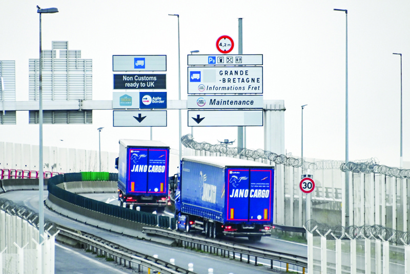 Two trucks take the direction of the Channel Tunnel shuttles on January 4, 2021 in Coquelles. - Goods flowed smoothly across the Channel between Britain and France on January 4, the first working day since the completion of Brexit last week. Nearly 3,000 trucks have passed through the Channel Tunnel from France to Britain since the UK left the EU customs union and single market at midnight on December 31, in the final act of its divorce from the EU. (Photo by DENIS CHARLET / AFP)