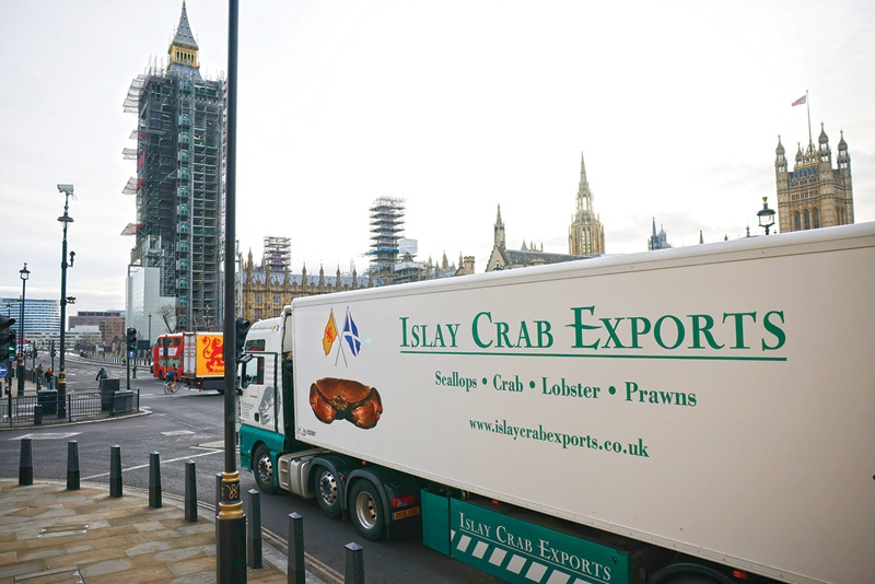 LONDON: Lorries from Scottish seafood companies drive past the Houses of Parliament in a protest action by fishermen against post-Brexit red tape and coronavirus restrictions, which they say could threaten the future of the industry, in London on Monday.-AFPnn