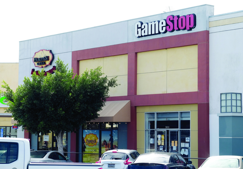 The GameStop logo sign is seen above the store in Culver City, California. Texas's attorney general announced on Friday a probe into Robinhood and 12 other online stock exchanges after they suspended trading on GameStop and other volatile equities. - AFPn