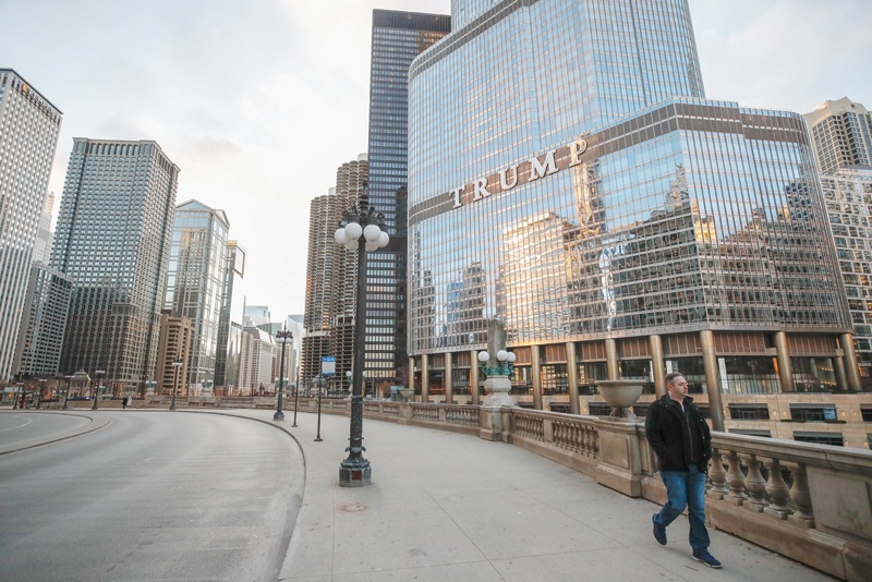 CHICAGO: In this file photo taken on March 21, 2020 a man walks by Trump International Hotel and Tower in Chicago, Illinois. Donald Trump shot to prominence with a business empire that bears his name, but after four years of political tumult capped by his supporters' violent attack on the Capitol, the US president's brand stands tarnished, threatening his businesses, experts say. - AFP
