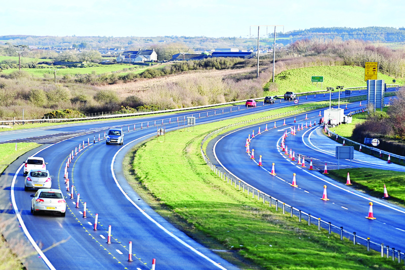 Cars travel through a contraflow system on the westbound A55 in Anglesey in north Wales on January 02, 2021. - The carriageway is closed to traffic to create queueing areas for vehicles travelling into Holyhead port and on to Dublin in Ireland. Portable toilet facilities have been set up along the route. Britain on Friday began a new year and life outside the European Union's single market, with the first trucks crossing the Channel by ferry and rail largely reporting few difficulties despite new customs rules. (Photo by Paul ELLIS / AFP)