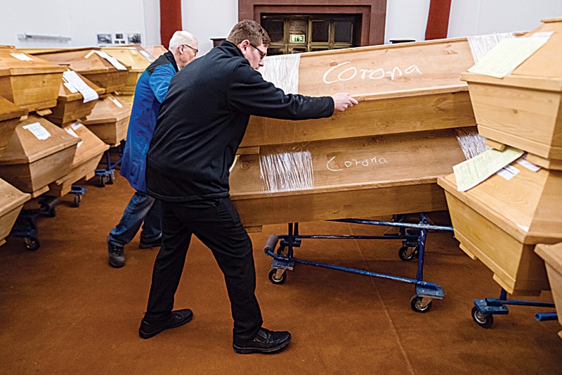 MEISSEN, Germany: Employees move coffins with the lettering 'corona' through the mourning hall before cremation at a crematorium on Wednesday. - AFP n