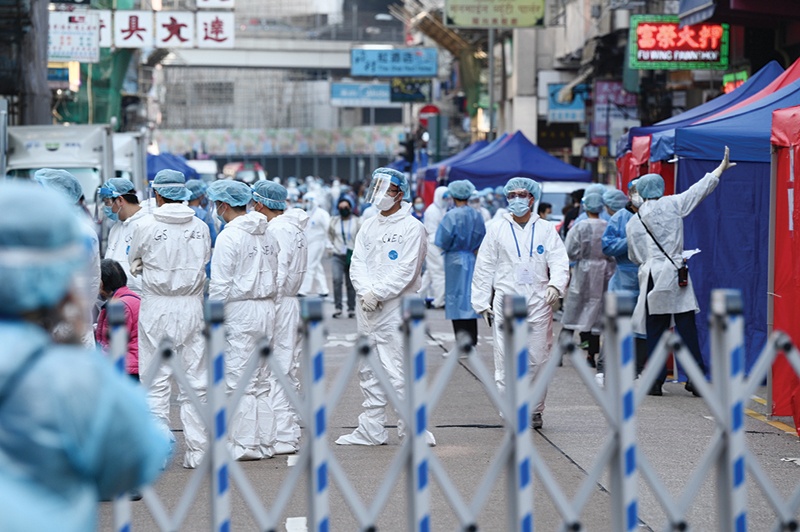 HONG KONG: Health workers conduct testing in the Jordan area of Hong Kong yesterday after thousands were ordered to stay in their homes for the city's first COVID-19 coronavirus lockdown as authorities battle an outbreak in one of its poorest and most densely packed districts. - AFP n