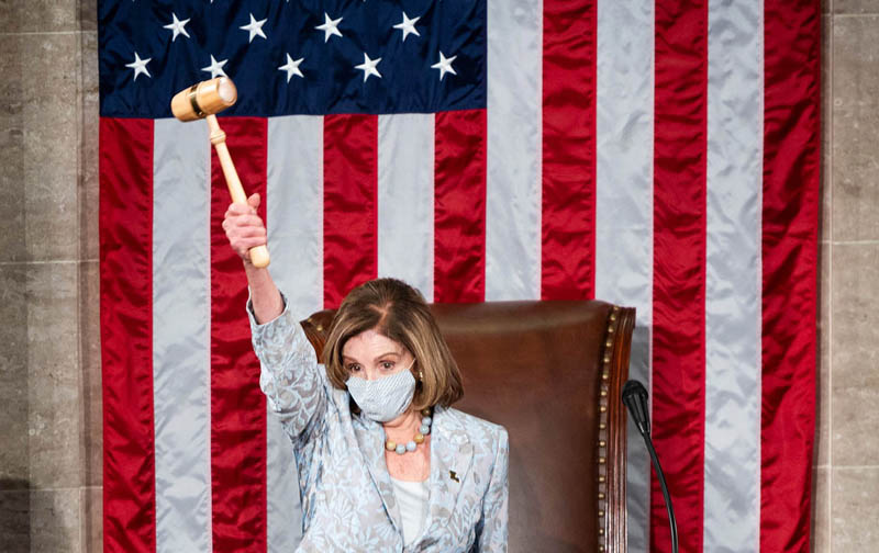 TOPSHOT - Speaker of the House Nancy Pelosi, D-Calif., holds the Speaker's gavel in the air on the House floor in the US Capitol after becoming Speaker of the 117th Congress in Washington, DC on January 03, 2021. (Photo by Bill Clark / POOL / AFP)