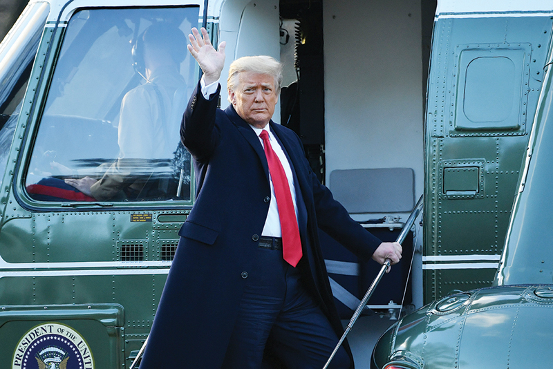 WASHINGTON: Outgoing US President Donald Trump waves as he boards Marine One at the White House yesterday. - AFP n