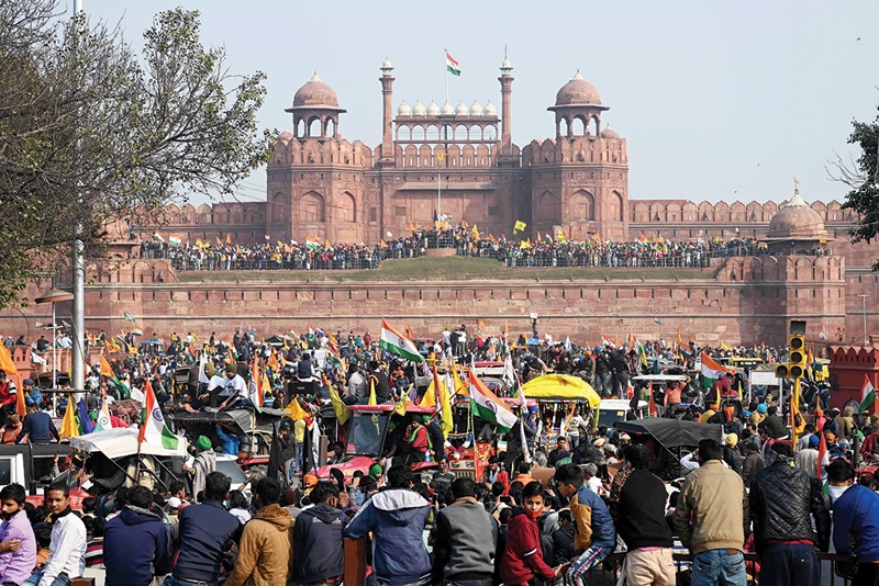 NEW DELHI: Farmers stand on the ramparts of Red Fort as they protest against the central government's recent agricultural reforms yesterday. – AFP n