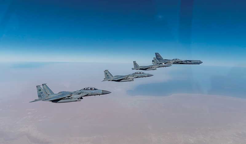 A US Air Force B-52 Stratofortress flies with Royal Saudi Arabian Air Force F-15SAs during a bomber taskforce mission over the US Central Command area of responsibility yesterday. - AFP n