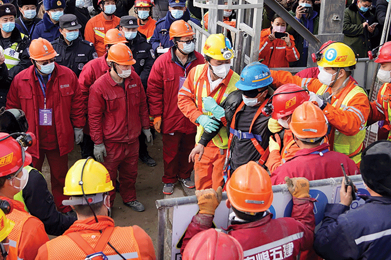 QIXIA, China: One (blue helmet) of 22 Chinese miners is rescued yesterday from hundreds of meters underground after being trapped for two weeks after a goldmine explosion. - AFP n