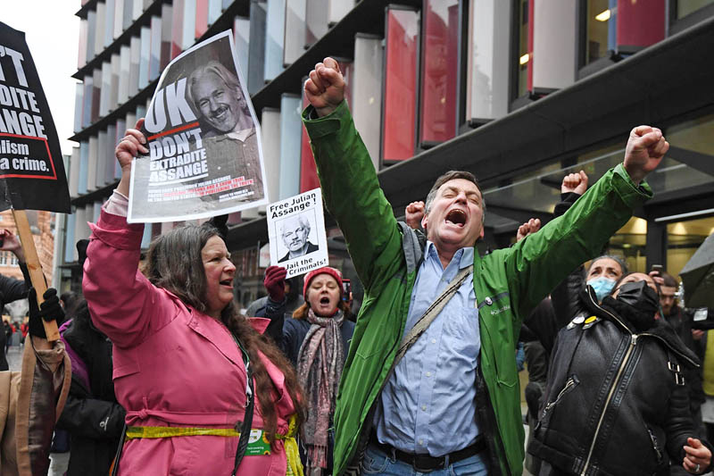 Supporters of Wikileaks founder Julian Assange celebrate outside the Old Bailey court in central London after a judge ruled that Assange should not be extradited to the United States to face espionage charges for publishing secret documents online on January 4, 2021. (Photo by DANIEL LEAL-OLIVAS / AFP)