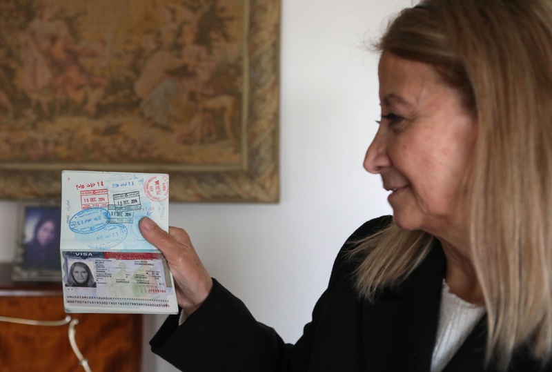 DAMASCUS: Dahouk Idriss shows a page on her passport during an interview at her home in the Syrian capital on Jan 16, 2021. – AFP n