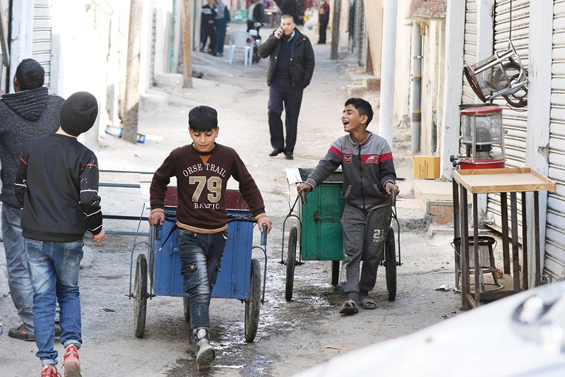 AMMAN: Jordanian youths using handcarts work in the capital's Wahdat district on Jan 10, 2021. - AFP 