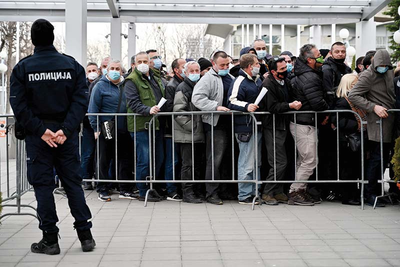 BELGRADE: People queue to receive the Chinese-made Sinopharm COVID-19 vaccine outside the Belgrade Fairground turned into a vaccination center yesterday. - AFP n