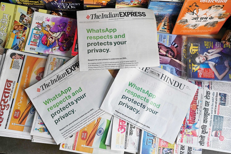 NEW DELHI: An advertisement by WhatsApp is seen in newspapers at a stall yesterday. - AFP n