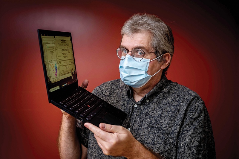 OrphAnalytics CEO Claude-Alain Roten poses with a laptop using text analysis software on Jan 6, 2021. - AFP n