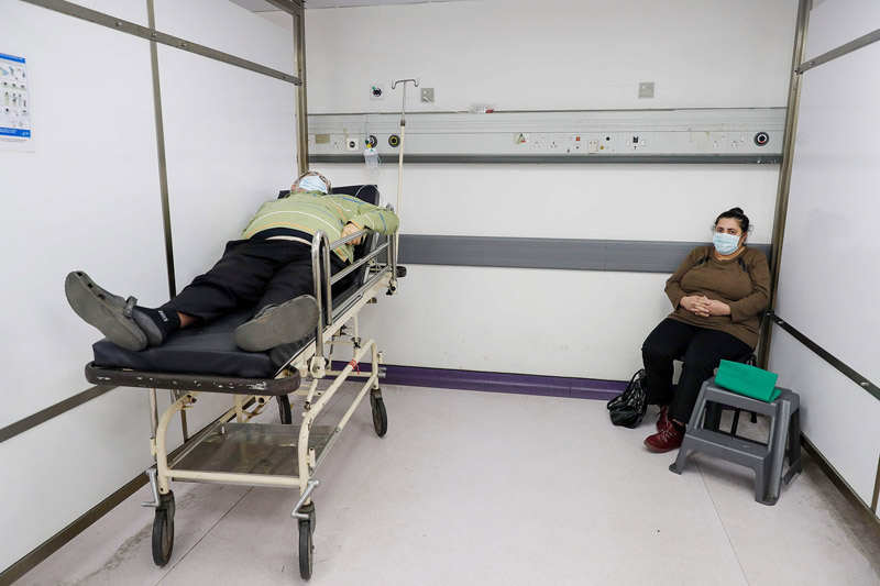 A man waits for treatment in the intensive care unit of the Rafic Hariri University Hospital in the Lebanese capital Beirut, on January 5, 2021. - With 192,000 reported cases and almost 1,500 deaths, Lebanon is not among the world's worst hit countries, but its infrastructure is crumbling and a small surge in infections is enough to take its health sector to breaking point. (Photo by JOSEPH EID / AFP)