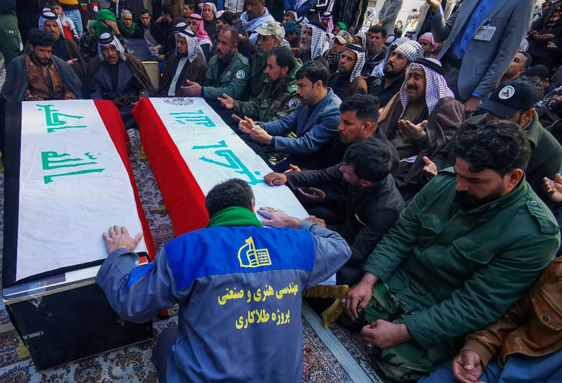 NAJAF: Supporters and members of Iraq's Hashed al-Shaabi force react by coffins of members of the powerful pro-Iran paramilitary network during a funeral ceremony in the holy city of Najaf on Sunday, a day after they were killed in an ambush north of the capital. - AFPn