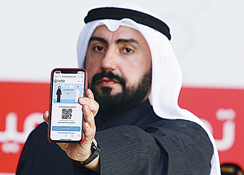 Minister of Health Sheikh Dr Basel Al-Sabah shows the QR code in the digital vaccine certificate.