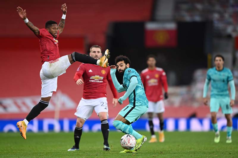 MANCHESTER: Manchester United's Brazilian midfielder Fred vies with Liverpool's Egyptian midfielder Mohamed Salah during the English FA Cup fourth round football match between Manchester United and Liverpool at Old Trafford yesterday. - AFP n