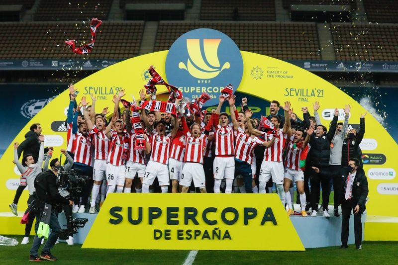 SEVILLE: In this handout picture released by RFEF (Spanish Royal Football Federation) Athletic Bilbao players celebrate after winning the Spanish Super Cup final football match between FC Barcelona and Athletic Club Bilbao at La Cartuja stadium in Seville on Sunday. - AFPn