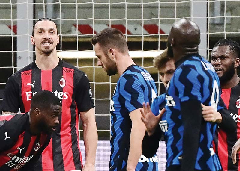 MILAN: AC Milan's Swedish forward Zlatan Ibrahimovic (left) argues with Inter Milan's Belgian forward Romelu Lukaku (right) at the end of the first half of the Italian Cup quarter final football match between Inter Milan and AC Milan on Tuesday at the Meazza stadium in Milan. - AFPn